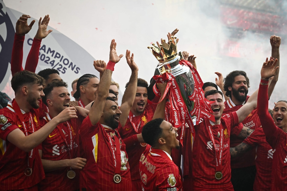 Liverpool's celebrate with the Premier League trophy at the end of the English Premier League football match between Liverpool and Crystal Palace at Anfield in Liverpool, north west England on May 25, 2025. (Photo by Paul Ellis / AFP) 