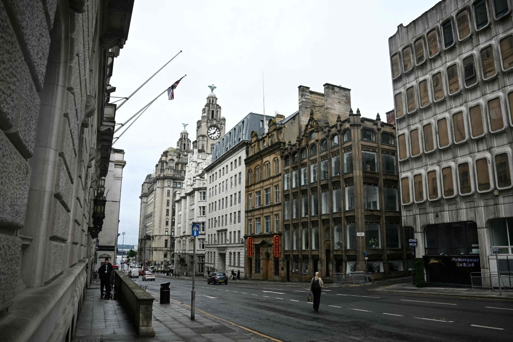 Pedestrians walk down Water Street in Liverpool, north-west England on May 28, 2025, where a car ploughed in to crowds that had gathered on May 26. (Photo by Paul Ellis / AFP)