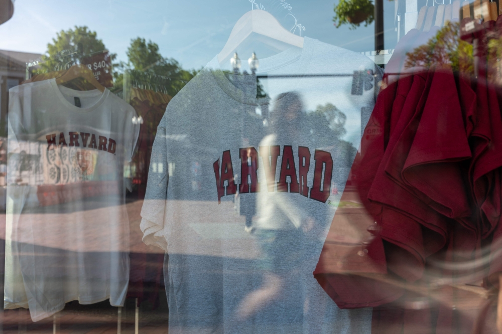 Harvard merchandise hangs in a window on May 28, 2025 in Cambridge, Massachusetts. (Photo by SPENCER PLATT / GETTY IMAGES NORTH AMERICA / Getty Images via AFP)