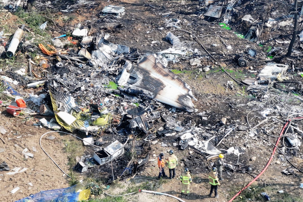 Firefighters work at the site where a South Korean navy maritime patrol aircraft crashed on a mountain in Pohang on May 29, 2025. (Photo by YONHAP / AFP)