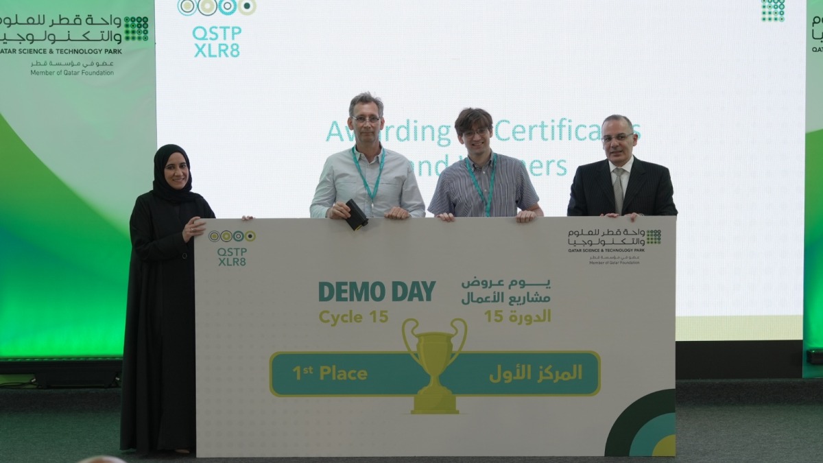 Innovation and Entrepreneurship Director at QSTP, Hayfa Al Abdulla with the first place winning team during the event.