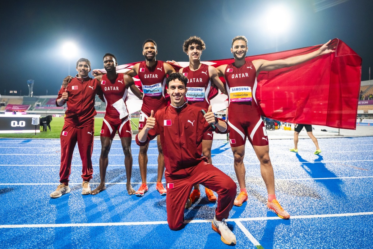 The members of the Qatar 4x400m relay team and 3000m steeplechase bronze medallist Zakaria Elahlaami (foreground) pose for a photo.