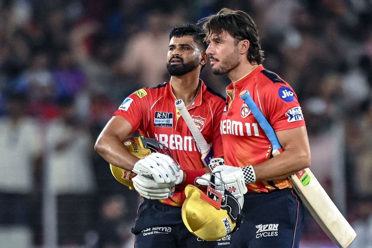 Punjab Kings' captain Shreyas Iyer (L) and his teammate Marcus Stoinis celebrate their team's win in the Indian Premier League (IPL) Twenty20 second Qualifier cricket match between Punjab Kings and Mumbai Indians at the Narendra Modi Stadium in Ahmedabad on June 2, 2025. (Photo by Arun SANKAR / AFP)
