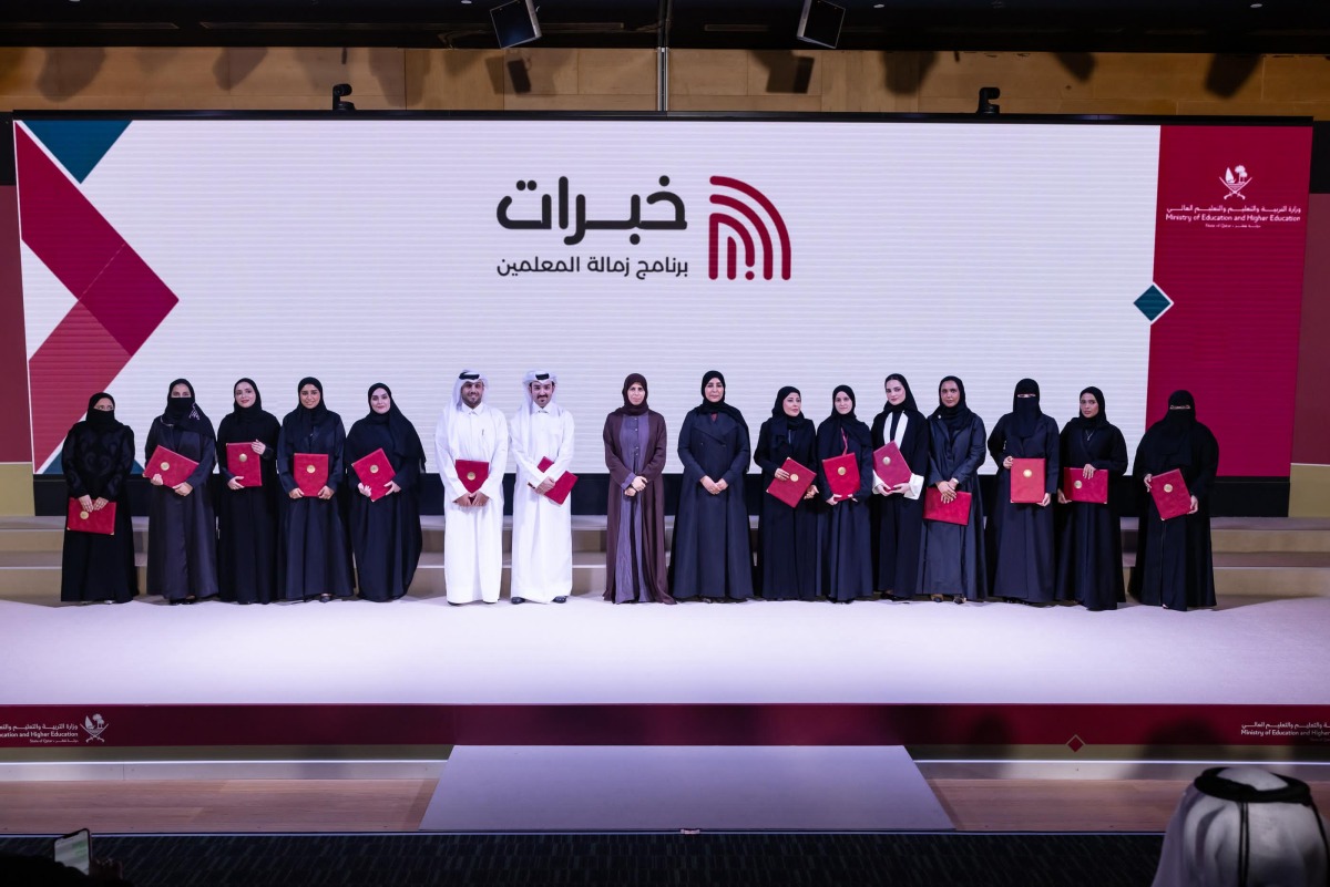 Minister of Education and Higher Education H E Lolwah bint Rashid bin Mohammed Al-Khater with graduating teachers of the “Khebrat” programme.