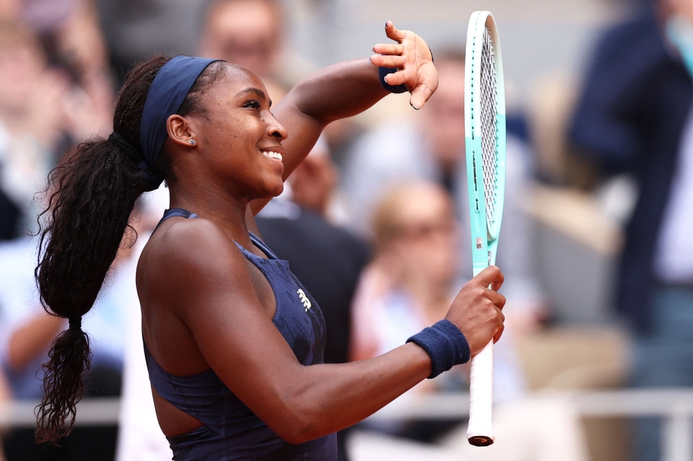 US Coco Gauff celebrates after winning against Russia's Ekaterina Alexandrova on day 9 of the French Open tennis tournament on Court Philippe-Chatrier at the Roland-Garros Complex in Paris on June 2, 2025. (Photo by Anne-Christine POUJOULAT / AFP)