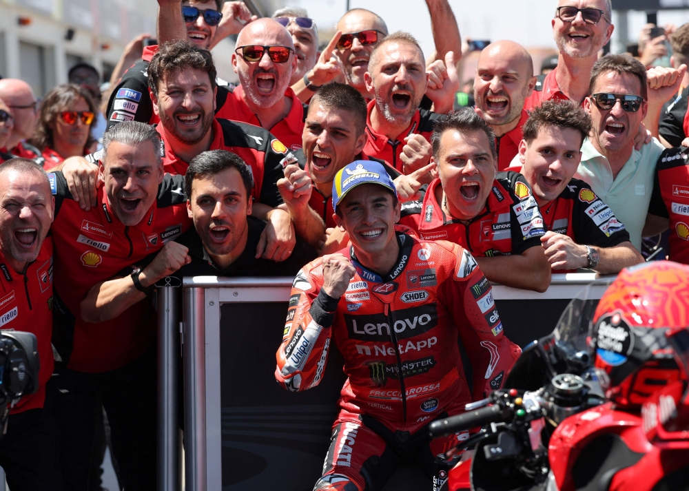 Team Ducati Lenovo Team's Marc Marquez celebrates with his team after winning the MotoGP Aragon Grand Prix race at the Motorland circuit in Alcaniz, northeastern Spain, on June 8, 2025. (Photo by Lluis Gene / AFP)