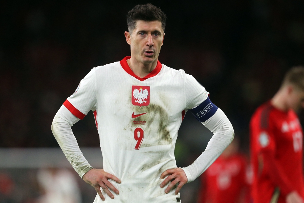 (Files) Poland's forward #09 Robert Lewandowski reacts during the UEFA EURO 2024 qualifier play-off between Wales and Poland, in Cardiff, on March 26, 2024. (Photo by Geoff Caddick / AFP)