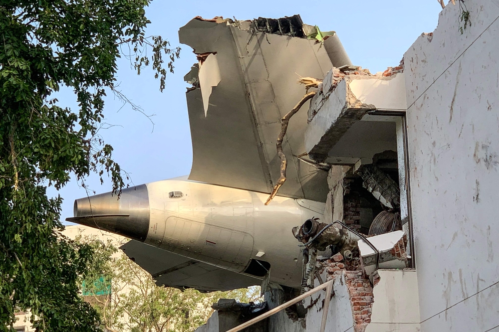 The back of Air India flight 171 is pictured at the site after it crashed in a residential area near the airport in Ahmedabad on June 12, 2025. (Photo by Sam Panthaky / AFP)