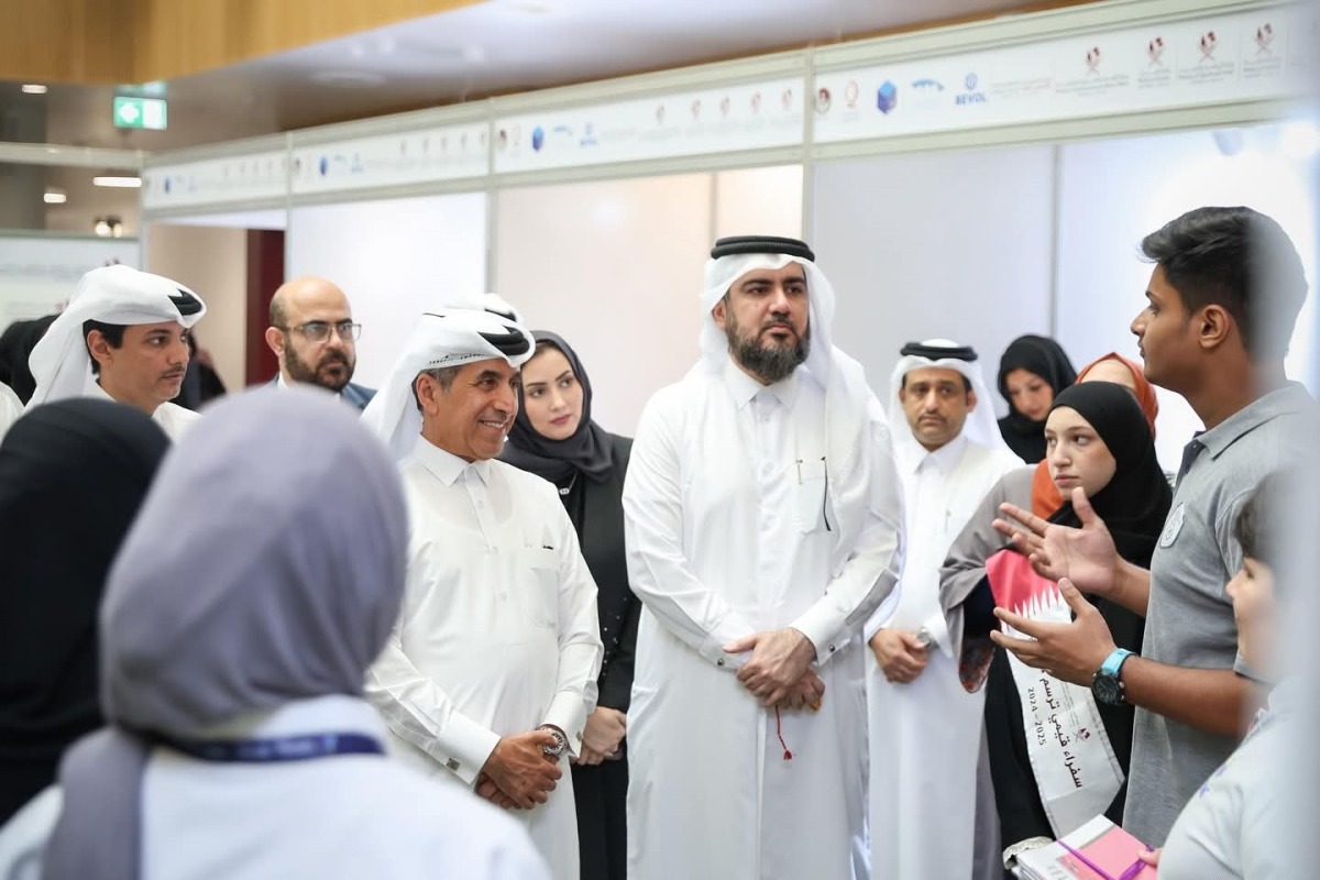 Undersecretary of the Ministry of Education and Higher Education Dr. Ibrahim bin Saleh Al Nuaimi along with other officials interacting with a student of PISQ during the event.