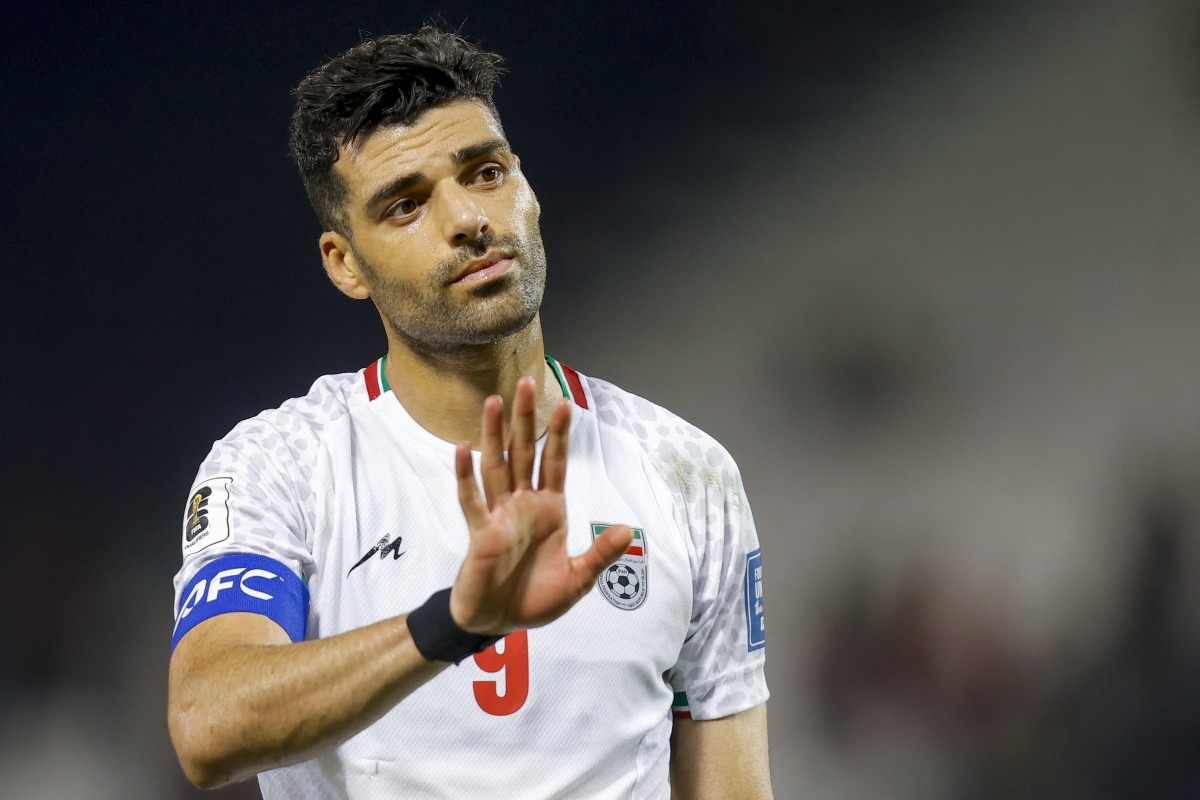 Iran's forward #09 Mehdi Taremi greets the fans ater the 2026 FIFA World Cup Asian Qualifier football match between Qatar and Iran at Jassim Bin Hamad Stadium in Doha on June 5, 2025. (Photo by Karim JAAFAR / AFP)