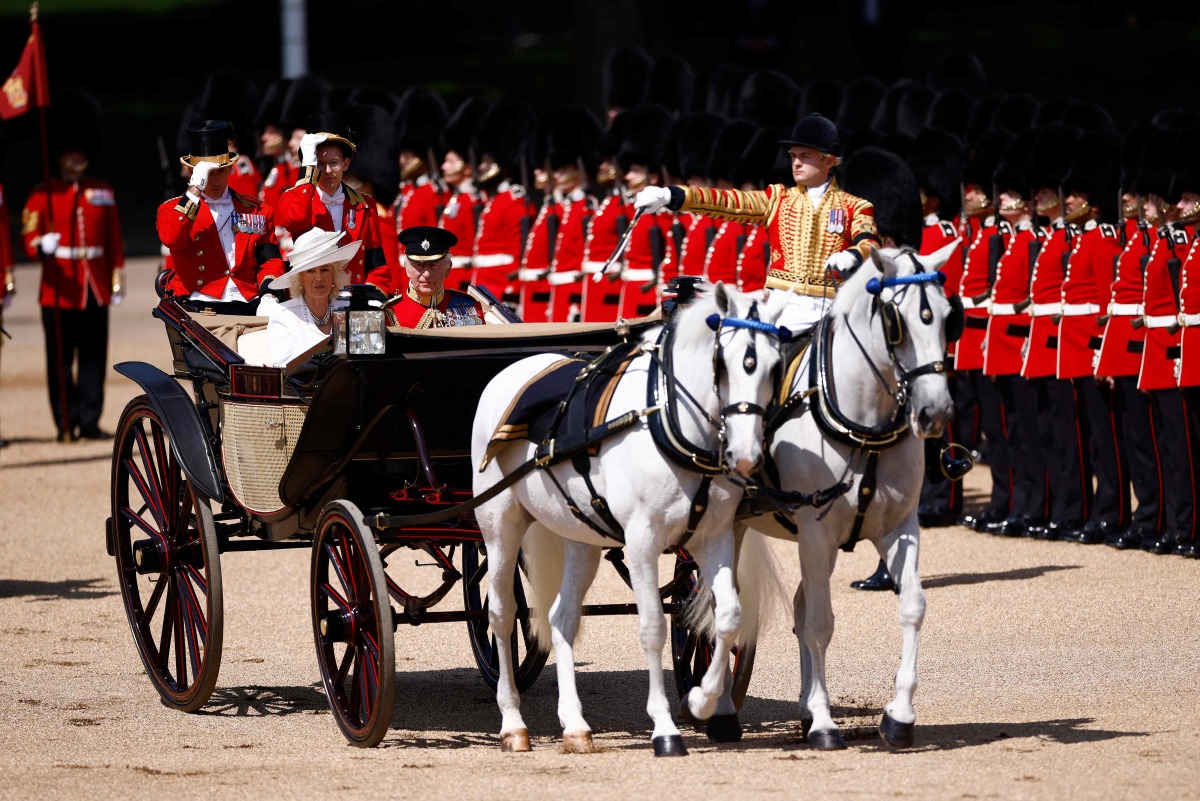 Britain's King Charles III and Britain's Queen Camilla arrive to Horse Guards Parade during the King's Birthday Parade, 