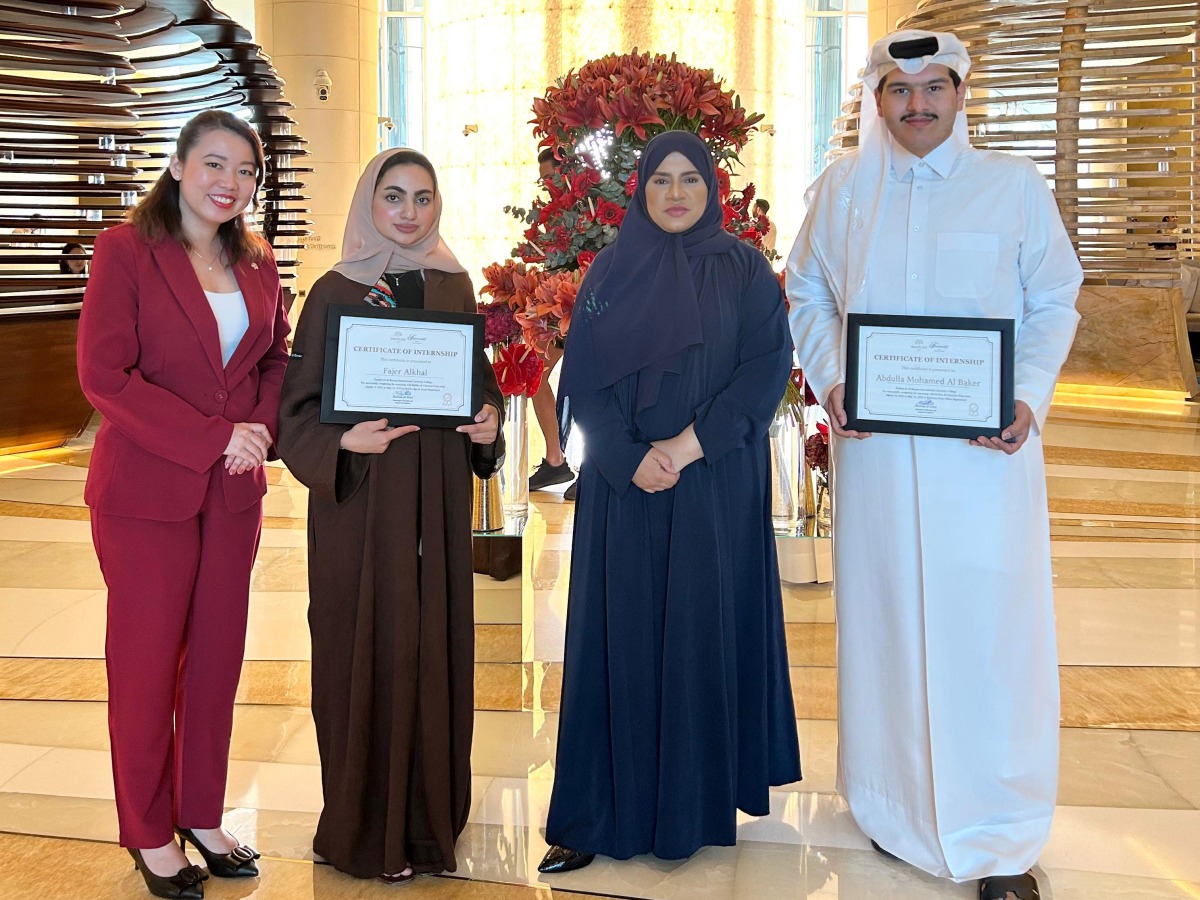 Katara Towers officials pose with some of the organisation's awards.