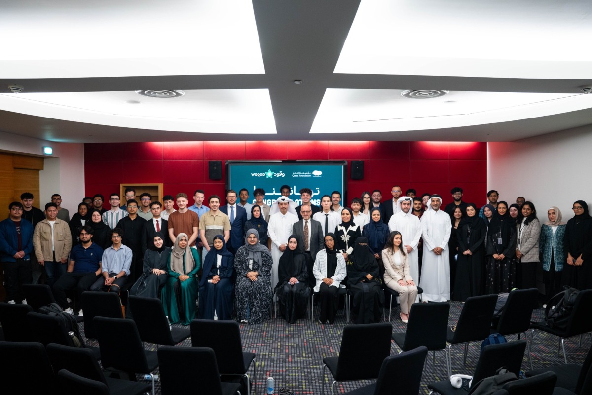 Officials with some students in a group photograph.