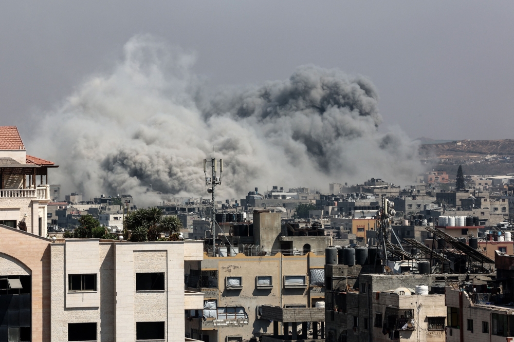 A plume of smoke billows in Jabalia in the northern Gaza Strip during an Israel strike on June 19, 2025. (Photo by Omar Al-Qattaa / AFP)
 