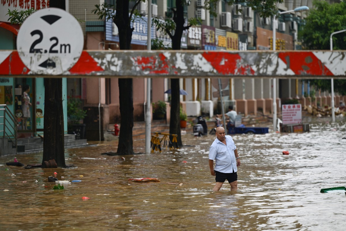 A man walks through a flooded street in Zhongshan, in China's southern Guangdong province on June 17, 2025. Photo by AFP.