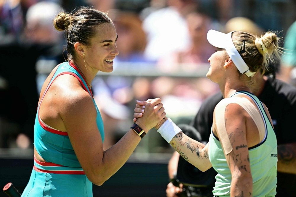 Belarus' Aryna Sabalenka (L) congratulates Czech Republic's Marketa Vondrousova after during their semi-final match at the WTA tennis tournament in Berlin on June 21, 2025. (Photo by Tobias Schwarz / AFP)