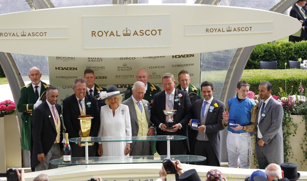 Britain's King Charles III and Queen Camilla pose with the connections of Lazzat, winner of the Queen Elizabeth II Jubilee Stakes on the final day of the Royal Ascot racing meeting.
