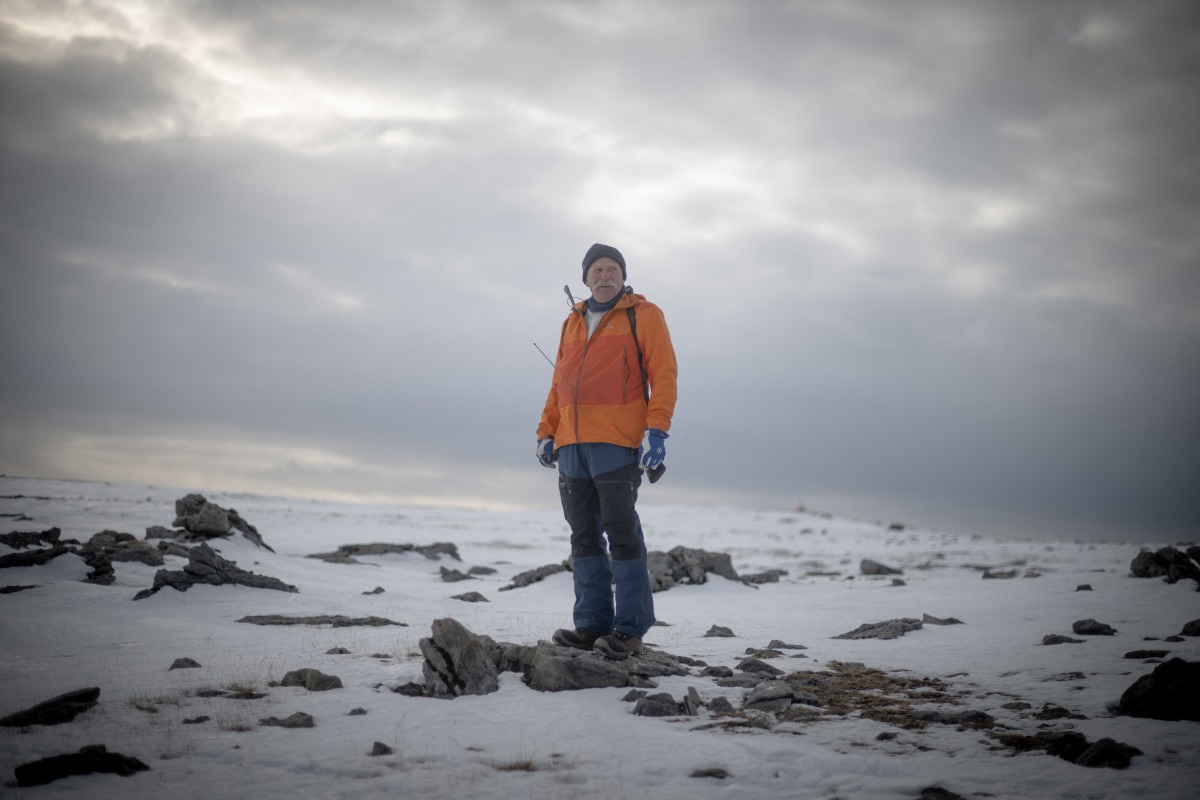 Norwegian Trond Robertsen (1st L), 65, patrols between barracks with a rifle in case of polar bear attack, at the weather station at the North Coast of remote Norwegian territory Bear Island (Bjornoya) on April 5, 2025. (Photo by Olivier Morin / AFP)
