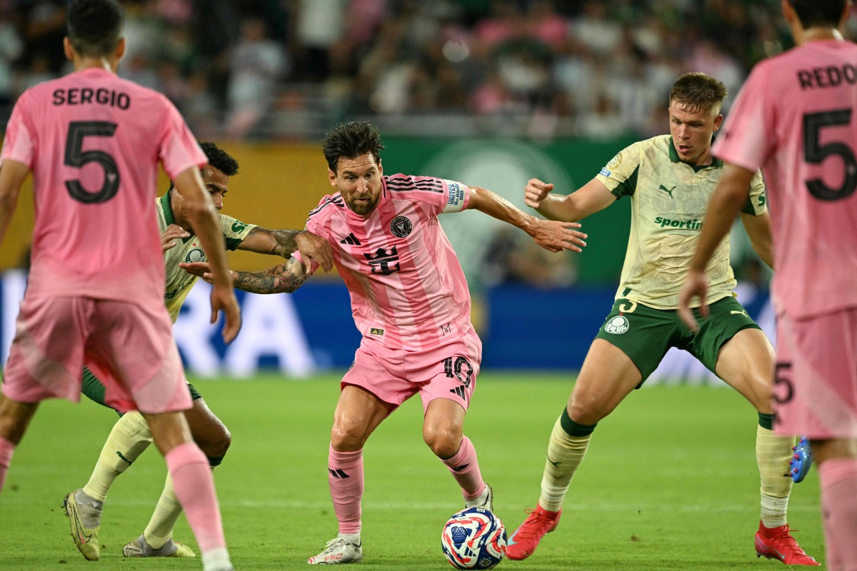 Inter Miami's Argentine forward #10 Lionel Messi (C) fights for the ball with Palmeiras' Brazilian midfielder #30 Lucas Evangelista (2nd L) and Palmeiras' Brazilian defender #03 Bruno Fuchs (2nd R) during the FIFA Club World Cup 2025 Group A football match between US Inter Miami and Brazil's Palmeiras at the Hard Rock stadium in Miami on June 23, 2025. (Photo by CHANDAN KHANNA / AFP)
