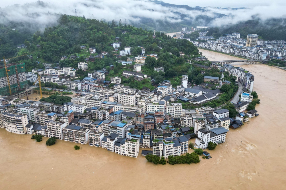 Flooded buildings are seen in Congjiang, in China's southwest Guizhou province on June 24, 2025. (Photo by AFP)