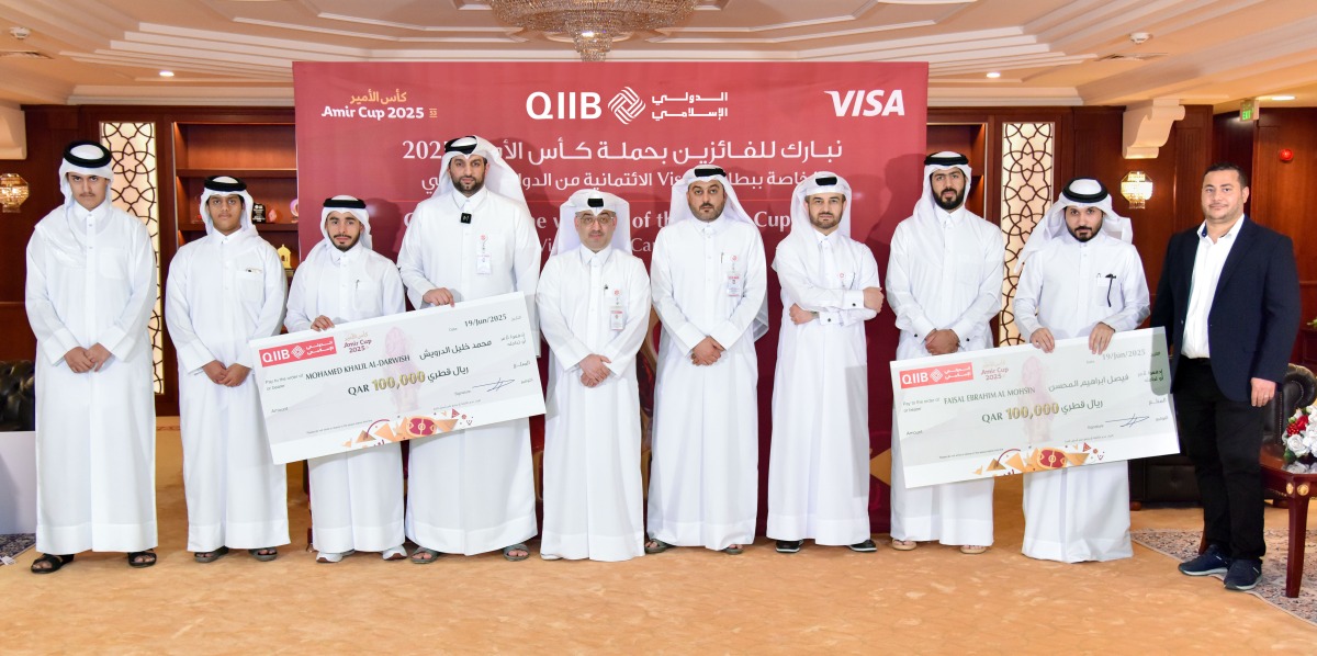 QIIB officials with winners of the promotion campaign.