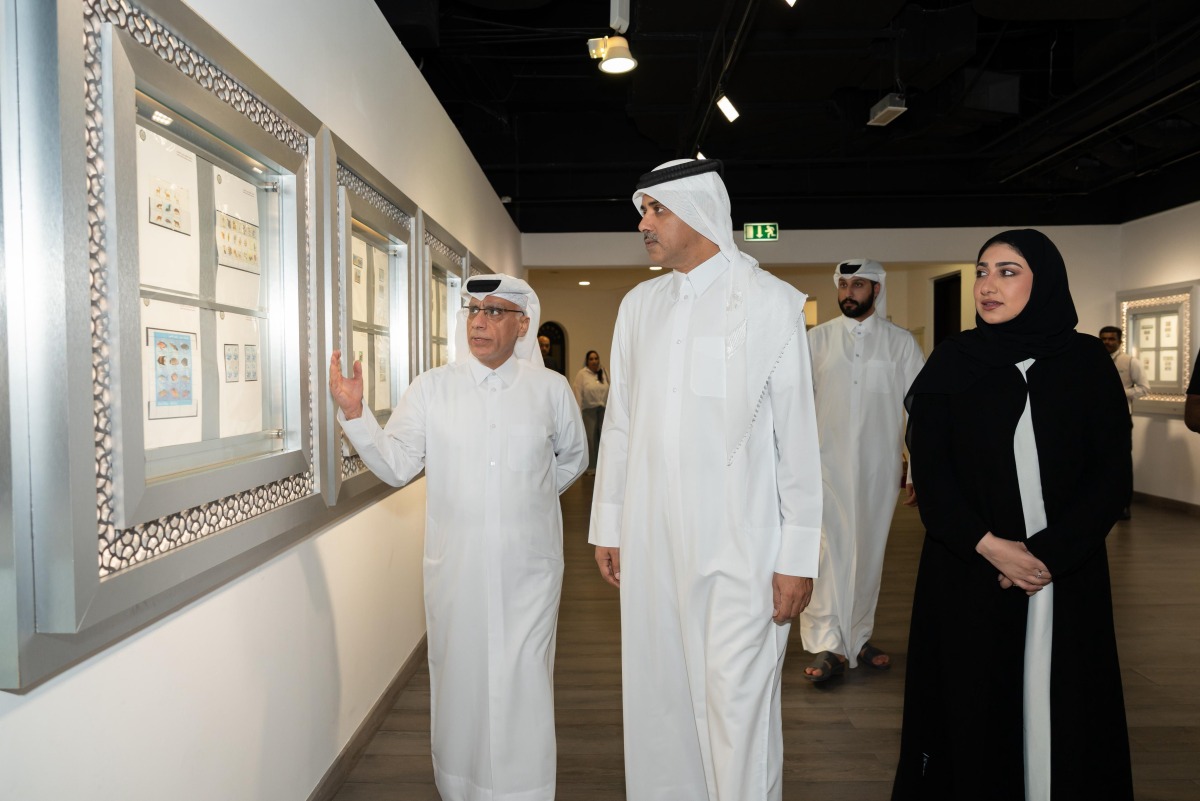 Officials admiring one of the works on display at the exhibition.