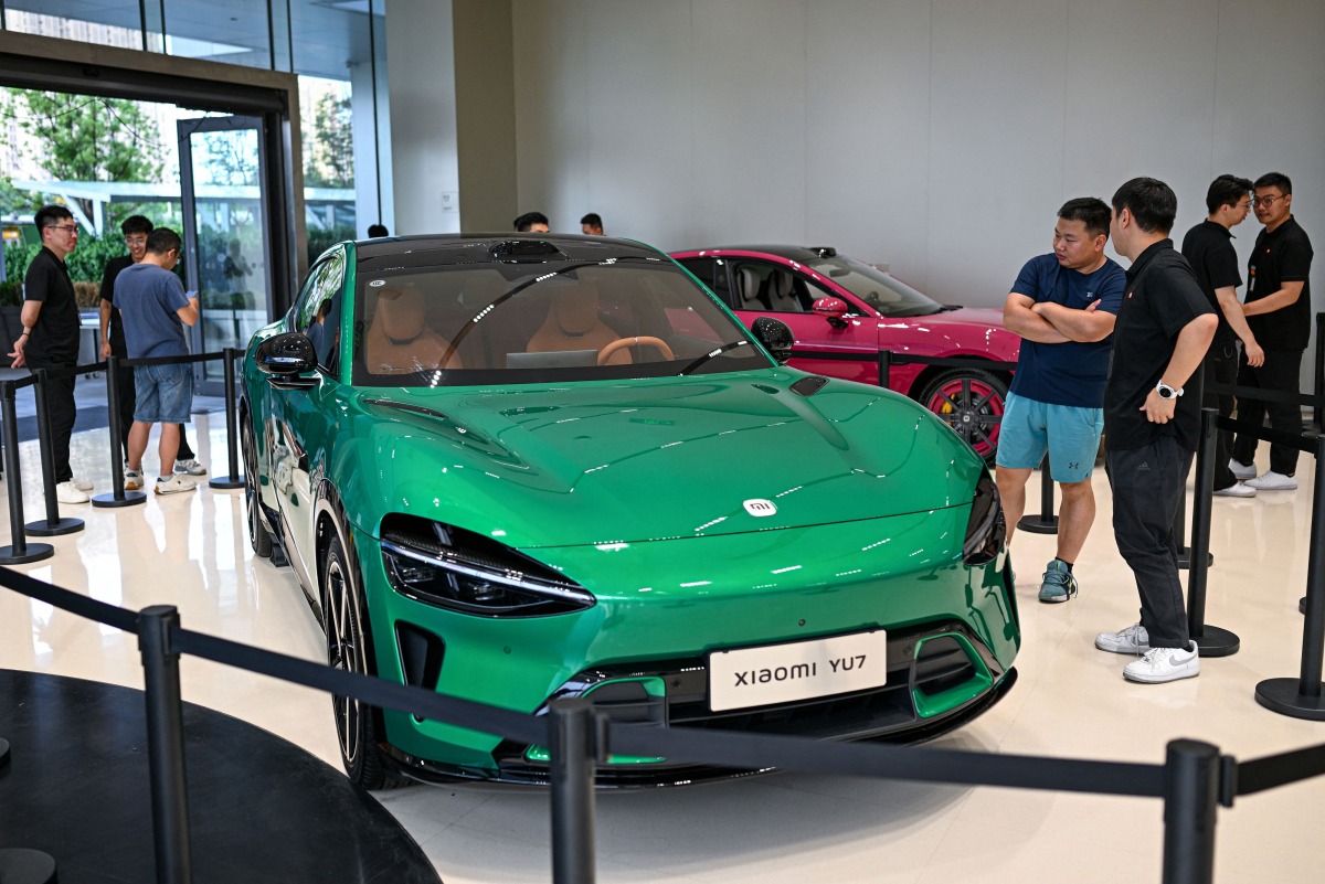 People look at a Xiaomi YU7 car at a showroom of Xiaomi store in Nanjing, in eastern China's Jiangsu province on June 26, 2025. (Photo by AFP)