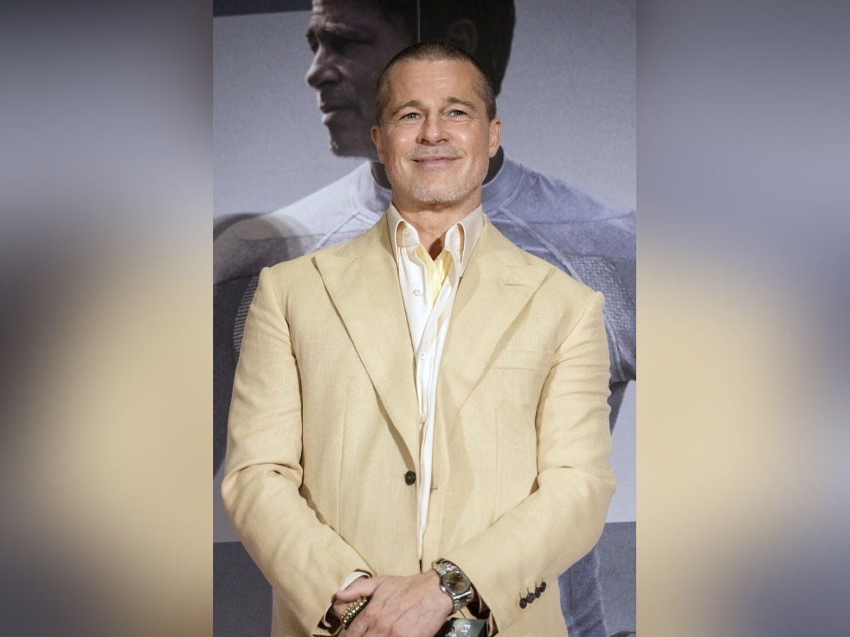 This photo taken on June 25, 2025 shows US actor Brad Pitt smiling on stage as he attends an event for his latest film 