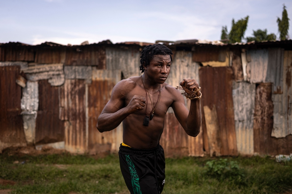 Abdullahi Ahmed, also known as Coronavirus, Dambe fighter from House Kudu, poses for a photograph in Mararaba in Nasarawa State, on June 26, 2025. (Photo by Olympia De Maismont / AFP)