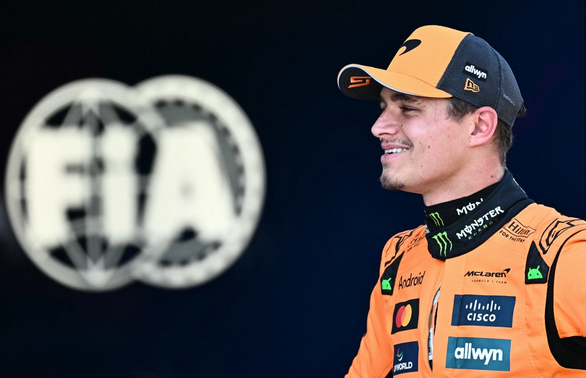 Pole position winner McLaren's British driver Lando Norris looks on next to the FIA logo after the qualifying session at the Red Bull Ring race track in Spielberg, Austria, on June 28, 2025, ahead of the Formula One Austrian Grand Prix. (Photo by Joe Klamar / AFP)
