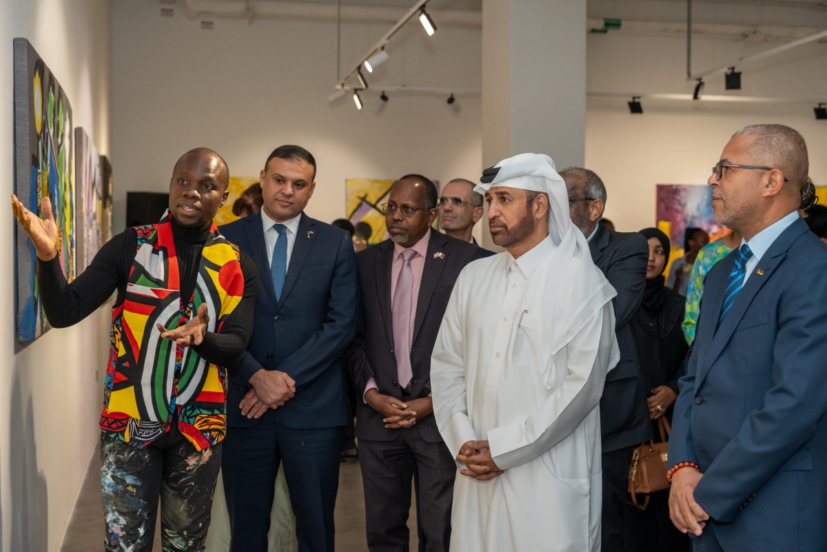General Manager of the Cultural Village Foundation, Katara Prof. Dr. Khalid bin Ibrahim Al-Sulaiti (second right) and other dignitaries listen to a presentation by Mozambican artist Sebastião Coana (left) at the event.