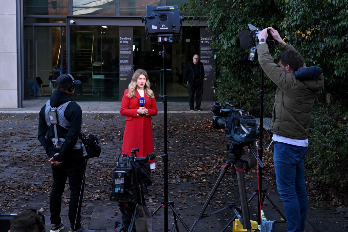 A television journalist prepares to speak in front of cameras as she stands outside the Latrobe Valley Magistrates' Court in Morwell on June 30, 2025. Photo by WILLIAM WEST / AFP