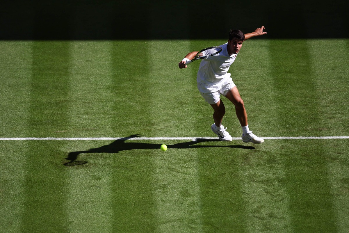 Spain’s Carlos Alcaraz plays a backhand return to Italy’s Fabio Fognini during their men’s singles first round match yesterday.