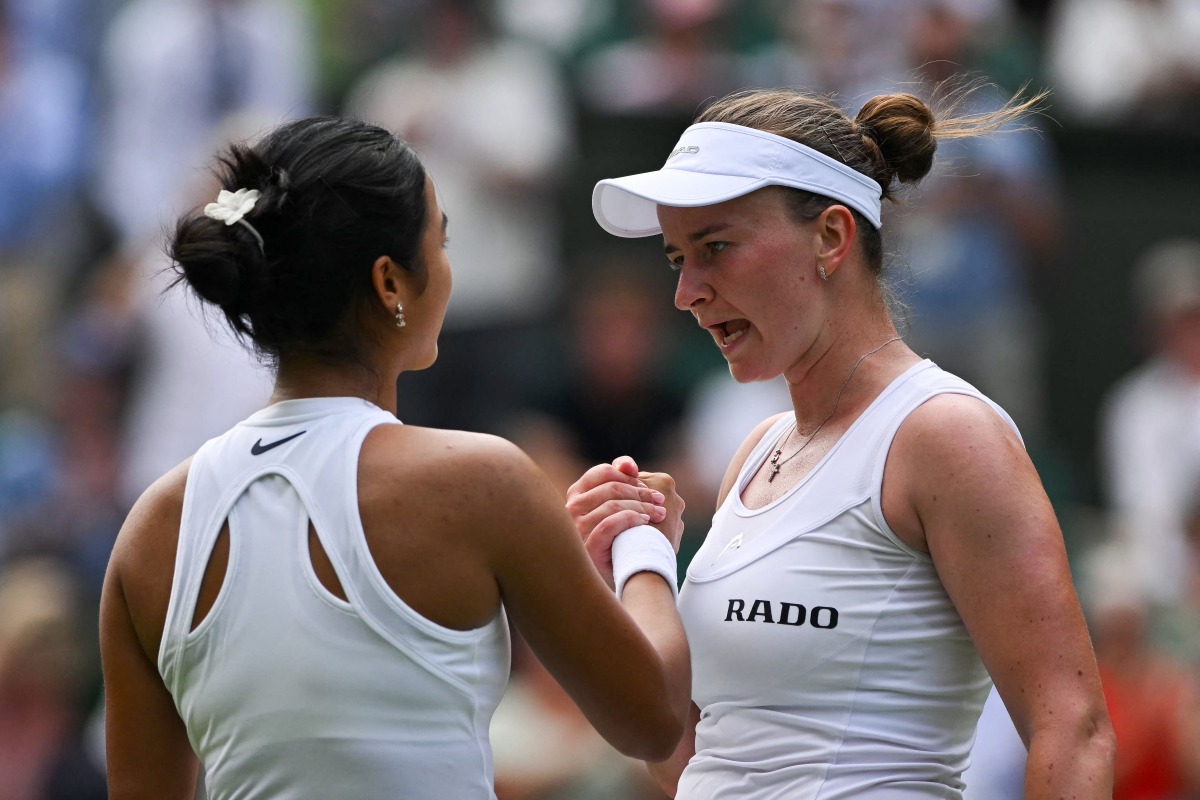 Czech Republic's Barbora Krejcikova (R) shakes hands with Philippines' Alexandra Eala after winning their women's singles first round tennis match on the second day of the 2025 Wimbledon Championships at The All England Lawn Tennis and Croquet Club in Wimbledon, southwest London, on July 1, 2025. (Photo by Glyn KIRK / AFP) 