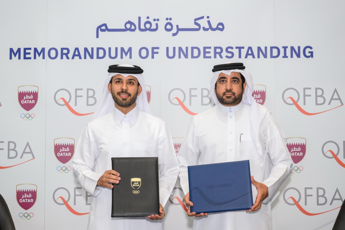 QOC Support Services Sector Director Hamad Lahdan Al-Muhannadi and Qatar Finance and Business Academy CEO Dr. Khalifa Al-Salahi Al-Yafei after signing the agreement.