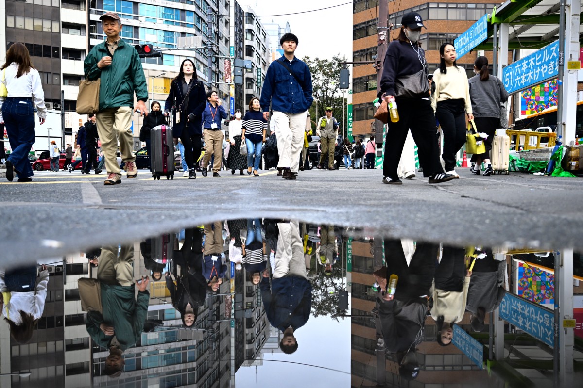 People walk through Shibuya area in Tokyo on November 15, 2024. (Photo by Yuichi YAMAZAKI / AFP)

