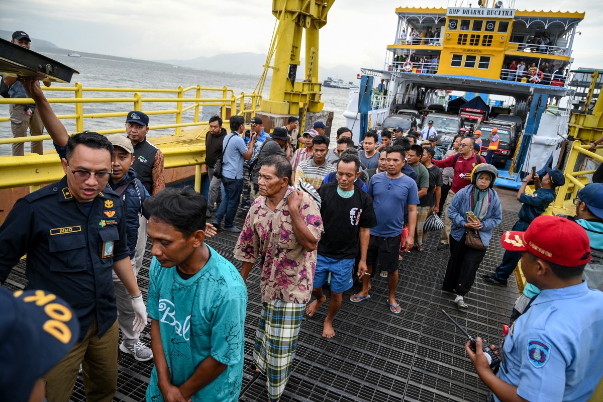The survivors of the sunken ferry accident arrive at Ketapang port aboard another ferry in Banyuwangi, East Java, on July 3, 2025, after being rescued and evacuated to Gilimanuk Port in Bali. Photo by AFP.