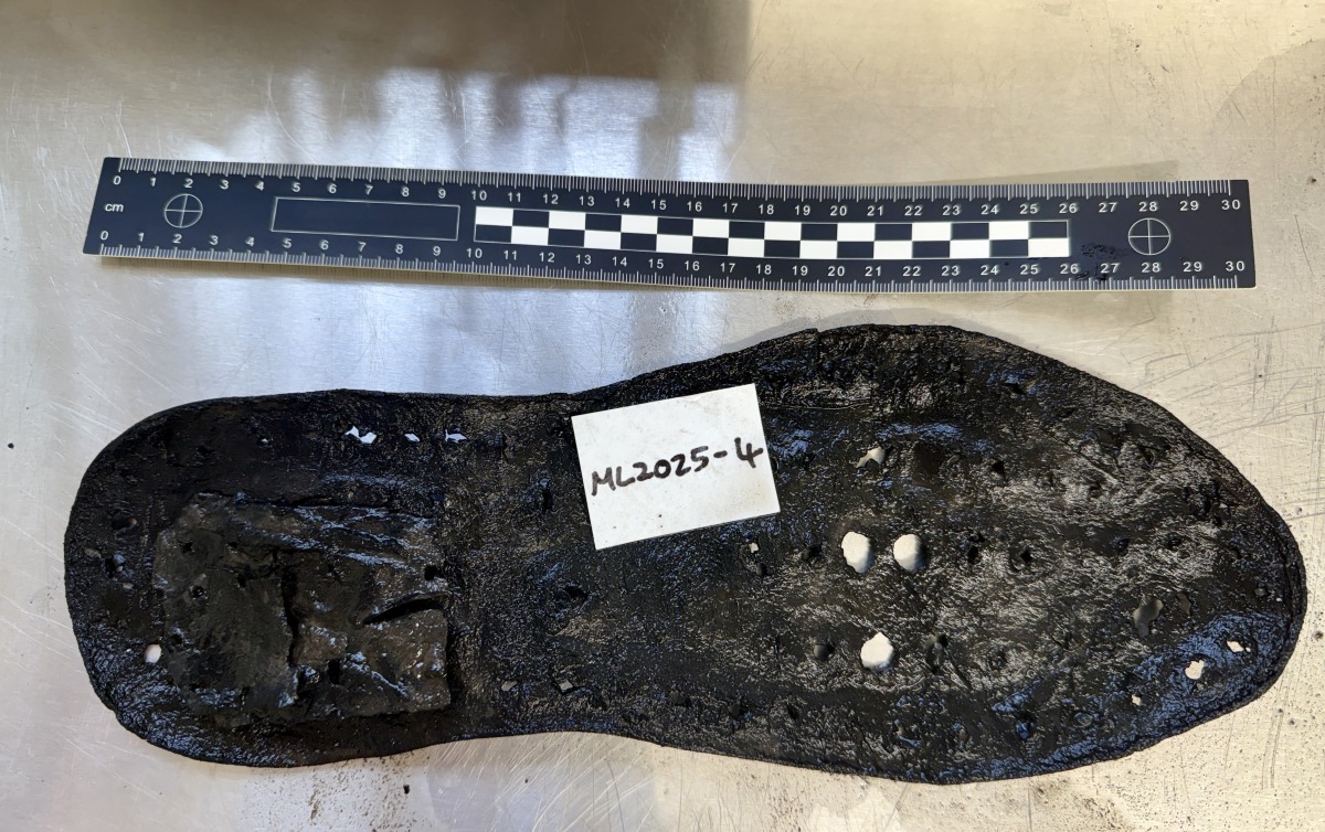 A June 19, 2025 handout photo released by The Vindolanda Trust in London on July 3, 2025, shows a section of a large leather shoe, one of 32 shoes uncovered so far, by the Trust during an excavation at Magna Roman Fort, near Greenhead, northeast England. Photo by The Vindolanda Trust / AFP.