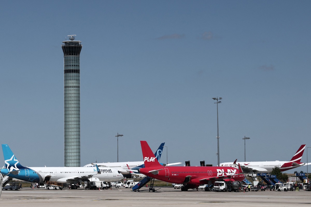 Planes are seen on the tarmac of Roissy Charles-de-Gaulle airport, outside Paris, on July 3, 2025, as French air traffic controllers launched a two-day strike to demand better working conditions, disrupting travel for tens of thousands of people at the start of a summer holiday season. Photo by Thibaud MORITZ / AFP.
