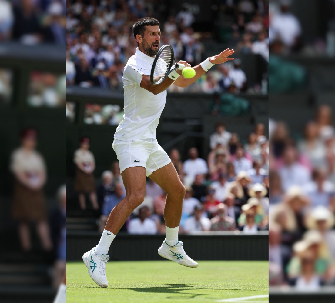 Serbia’s Novak Djokovic plays a forehand return to Britain’s Daniel Evans.