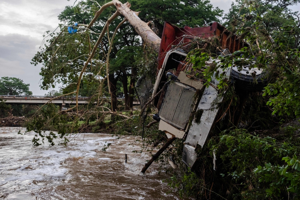  A large truck is impaled onto a tree after flash flooding on the bank Guadalupe River on July 5, 2025 in Center Point, Texas.
(Photo by Jim Vondruska / GETTY IMAGES NORTH AMERICA / Getty Images via AFP)