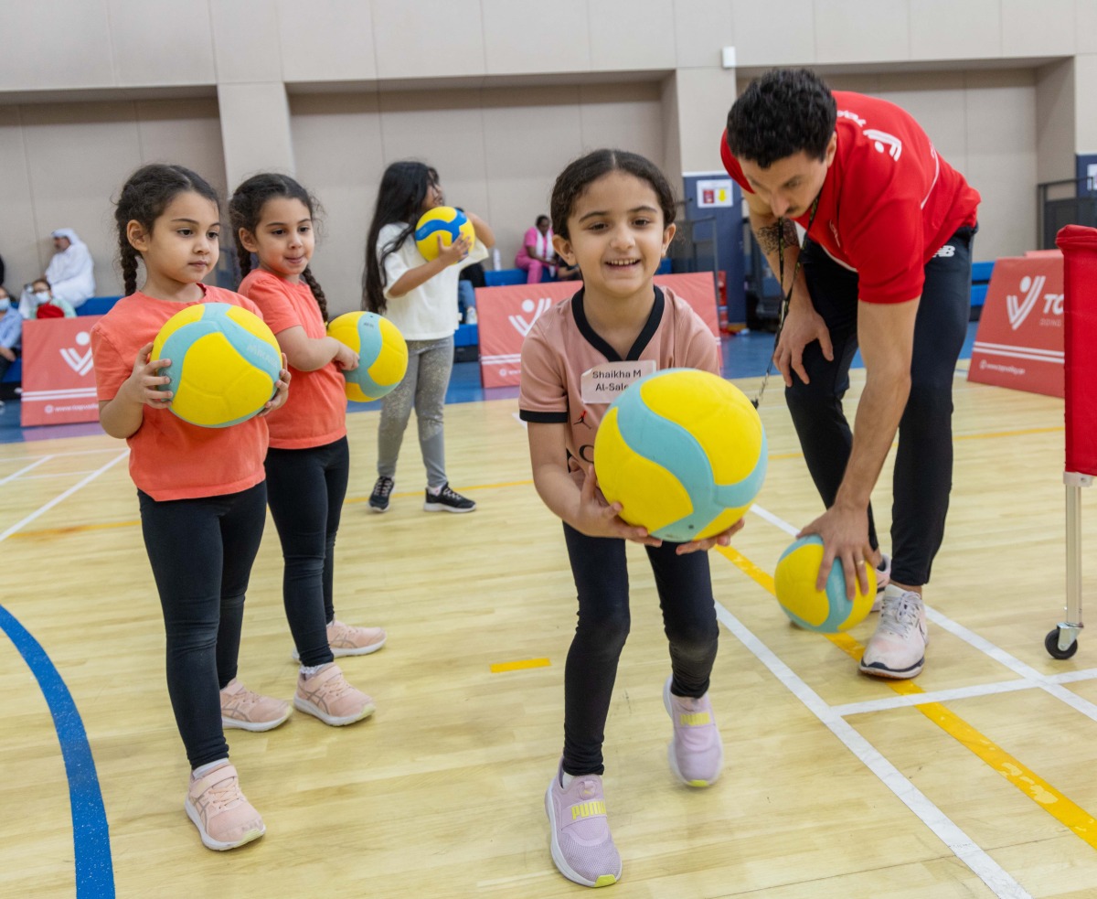 Children practice volleyball.
