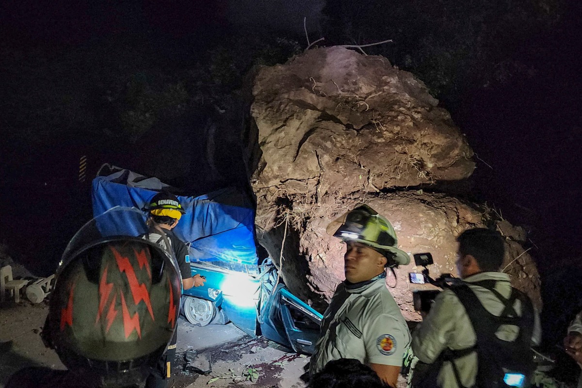 This handout picture released by the Bomberos Voluntarios de Guatemala shows volunteer firefighters working to recover the bodies of two people who died after their vehicle was buried in rocks and soil during a landslide as a result of earthquakes in Santa Maria de Jesus, Guatemala, on July 8, 2025. Photo by Bomberos Voluntarios de Guatemala / AFP