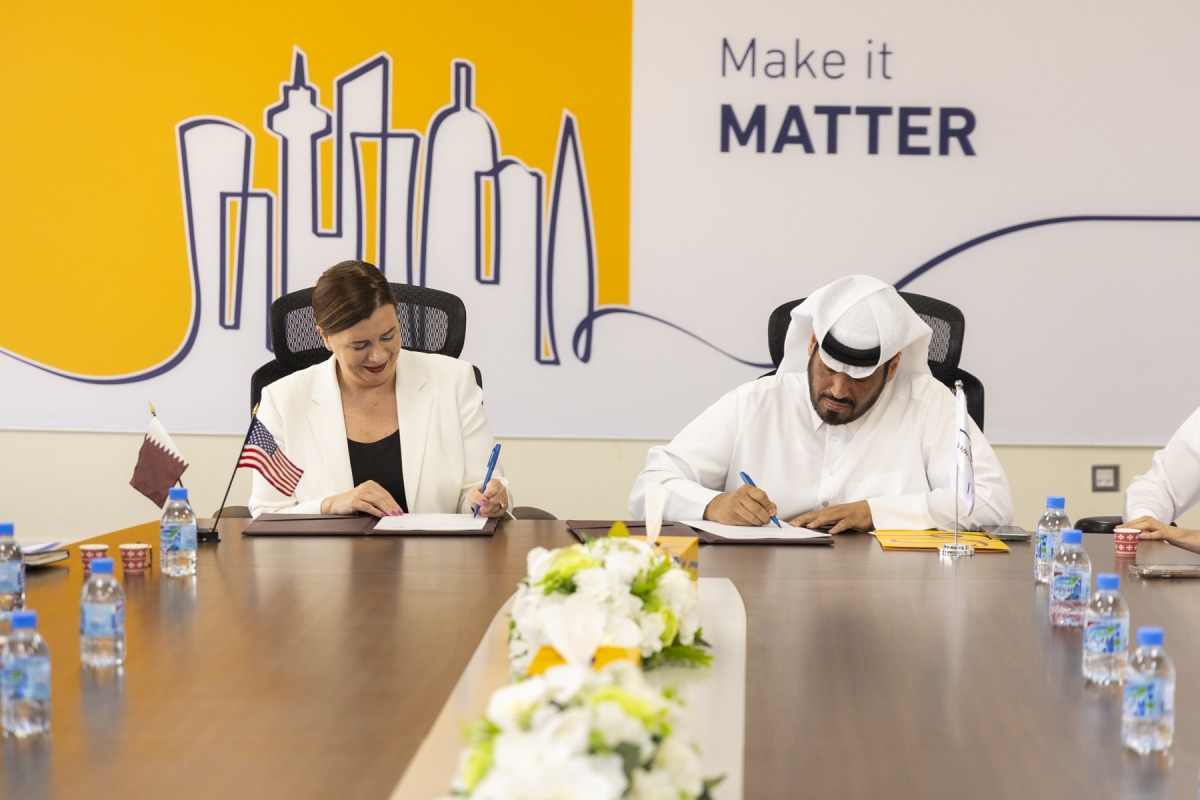 Acting Director General of Qatar Post Hamad Al Fahida  and Chargé d’Affaires at US Embassy Doha Stefanie Altman-Winans signing the agreement.