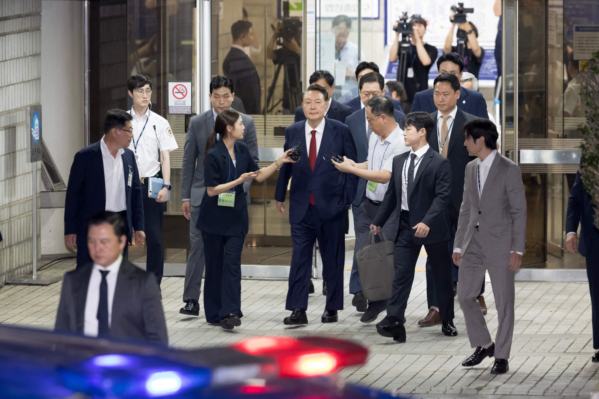 South Korea’s former president Yoon Suk Yeol (centre) leaves the Seoul Central District Court in Seoul on July 9, 2025, before being driven to the Seoul Detention Centre in Uiwang. (AFP)