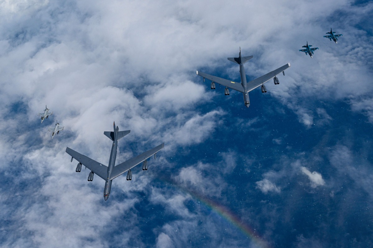 This handout photo taken on July 11, 2025 and provided by South Korean Defence Ministry shows US Air Force B-52H bombers (C), South Korean Air Force KF-16 fighter jets (L) and Japanese Air Self-Defense Force F-2 fighter jets (R) flying in formation during a joint air drill over international waters off South Korea's southern island of Jeju. (Photo by Handout / South Korean Defence Ministry / AFP) 