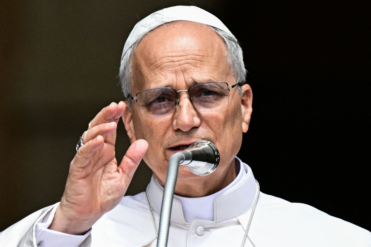 Pope Leo XIV addresses the crowd for the Angelus prayer in Piazza della Liberta (Liberty Square) in front of Palazzo Apostolico (Apostolic Palace) in the summer papal estate in Castel Gandolfo, 40 km southeast of Rome, on July 13, 2025. Photo by Tiziana FABI / POOL / AFP