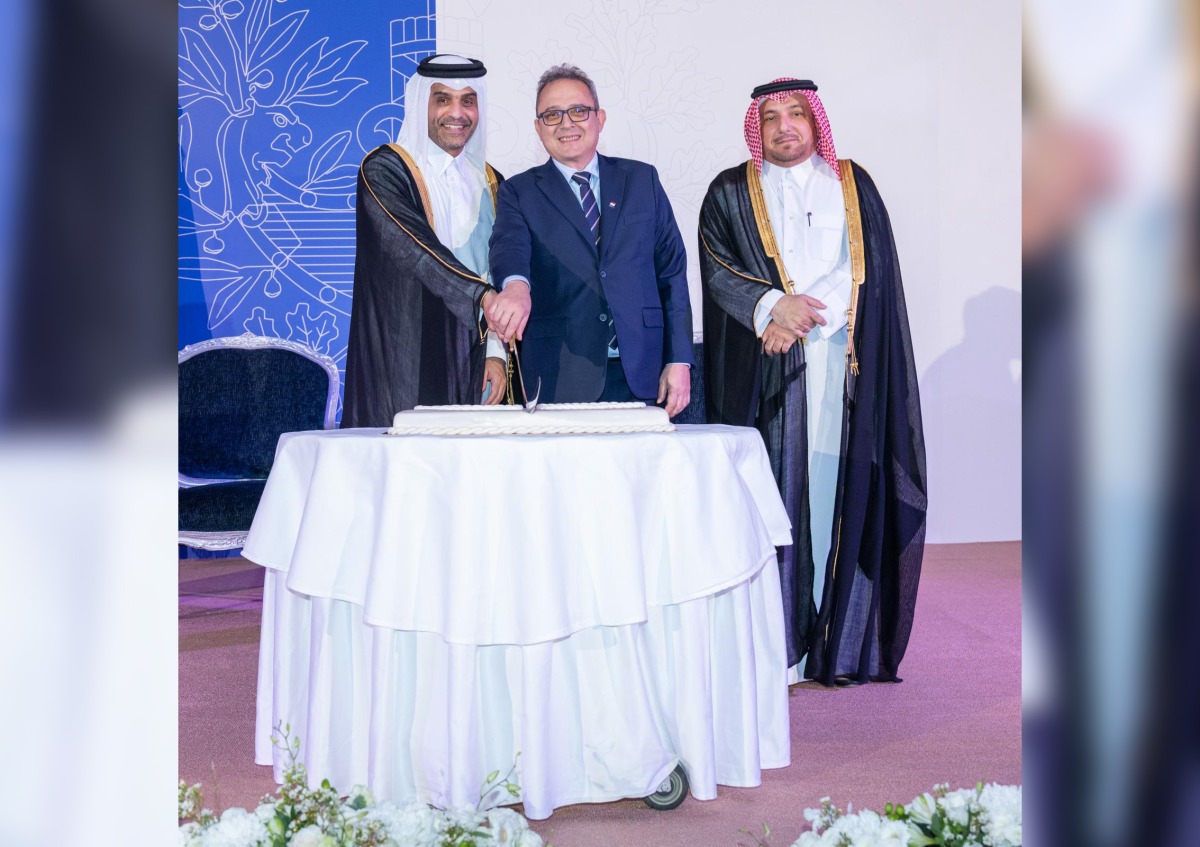 Minister of Transport H E Sheikh Mohammed bin Abdulla bin Mohammed Al Thani;  Director of Protocol at the Ministry of Foreign Affairs H E Ambassador Ibrahim Yousif Fakhroo and Chargé d’Affaires at the Embassy of France in Qatar, Patrick Poinsot cutting the ceremonial  cake to mark French National Day.