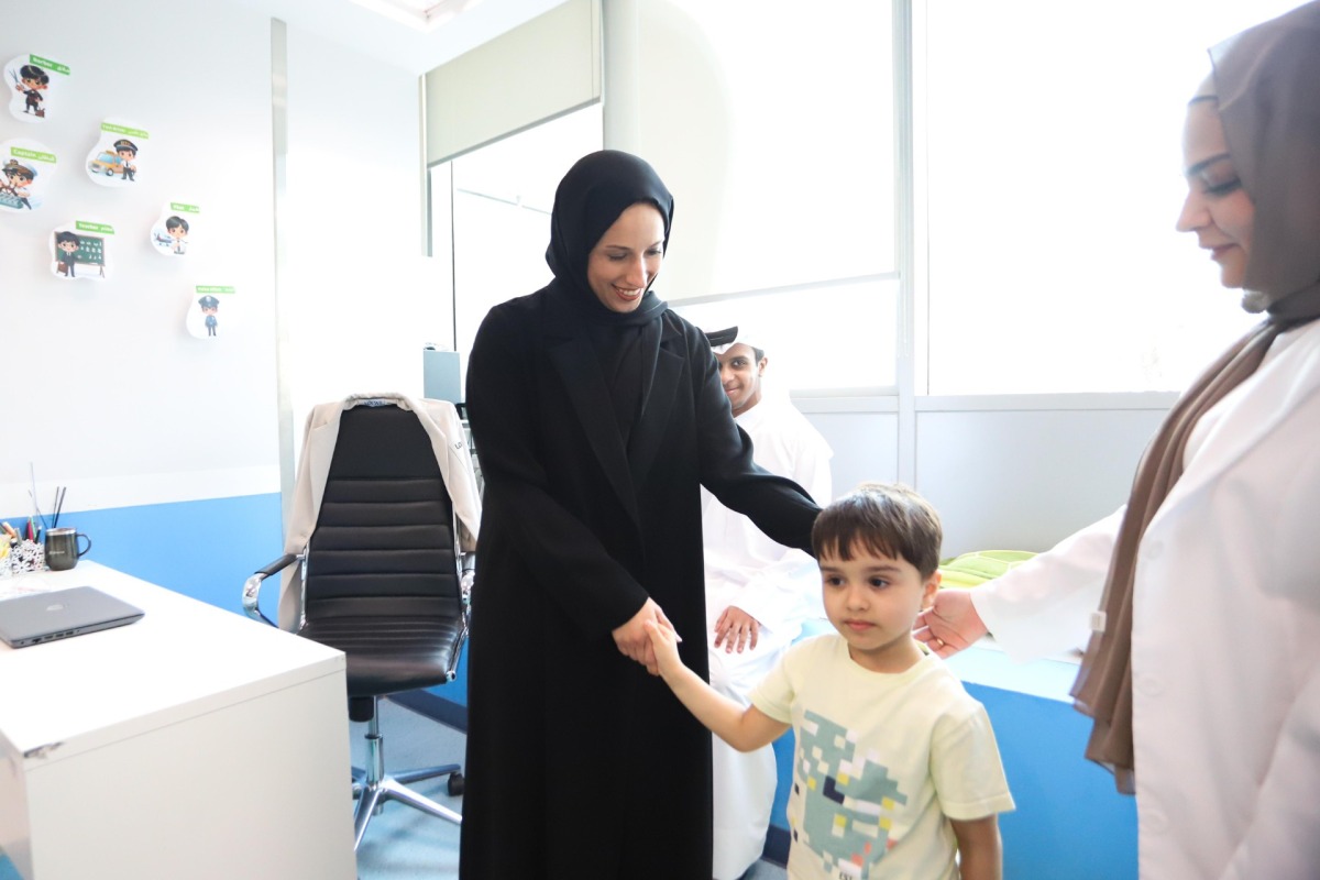 Minister of Social Development and Family H E Buthaina bint Ali Al Jabr Al Nuaimi interacting with a child during the launch of Early Intervention Program for children with Autism Spectrum Disorder yesterday.