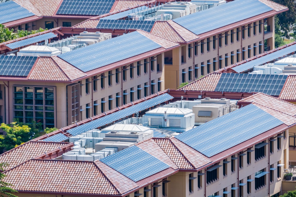 Solar panels installed on the tiled rooftops of buildings in San Francisco bay area, Silicon Valley in California, US.